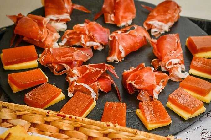 Presunto and cheese laid out on a slate