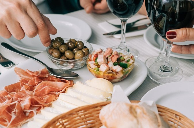 Presunto, olives and prawns laid out along a tavern table